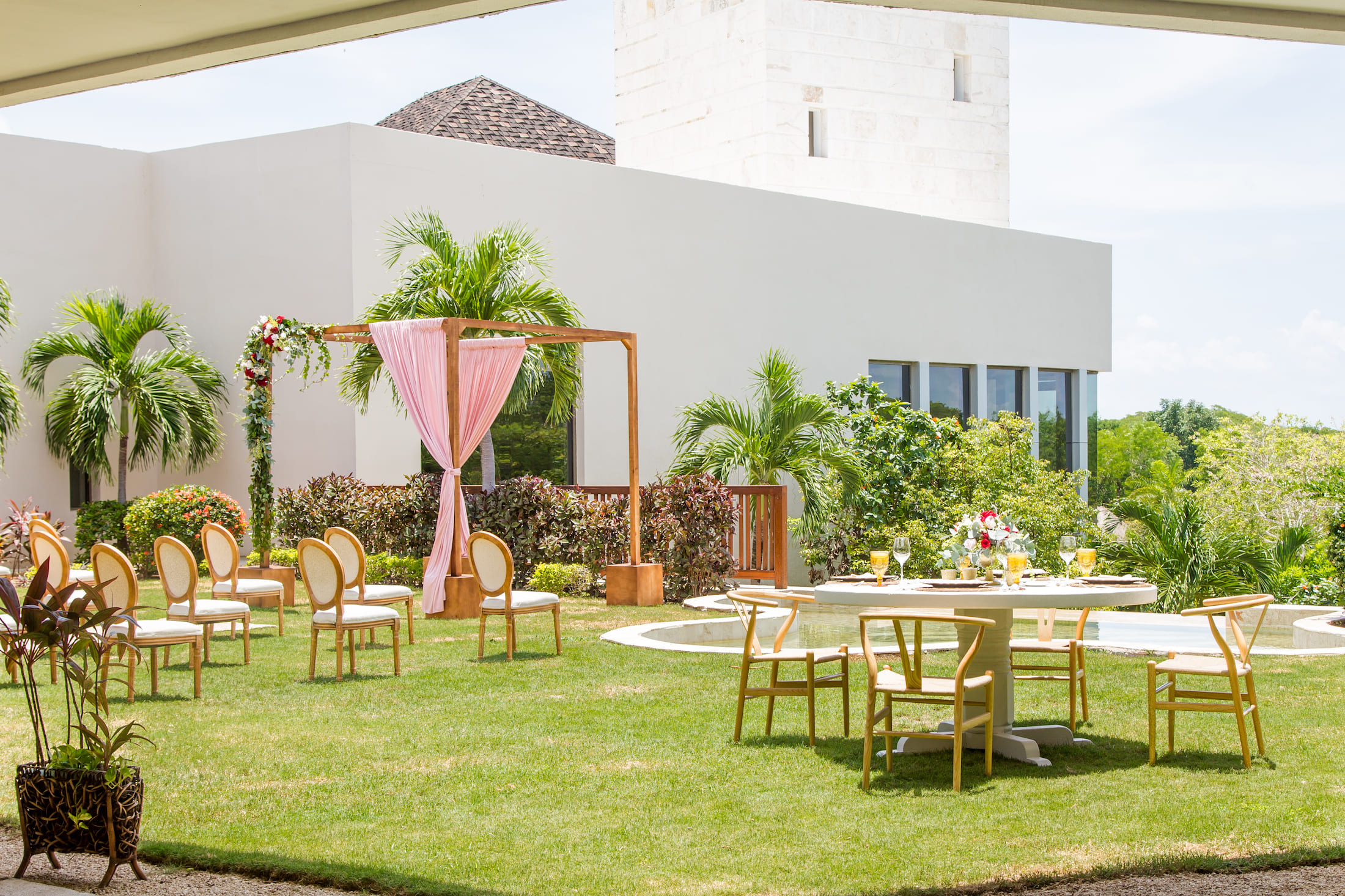 An outdoor wedding setting on a manicured lawn.
