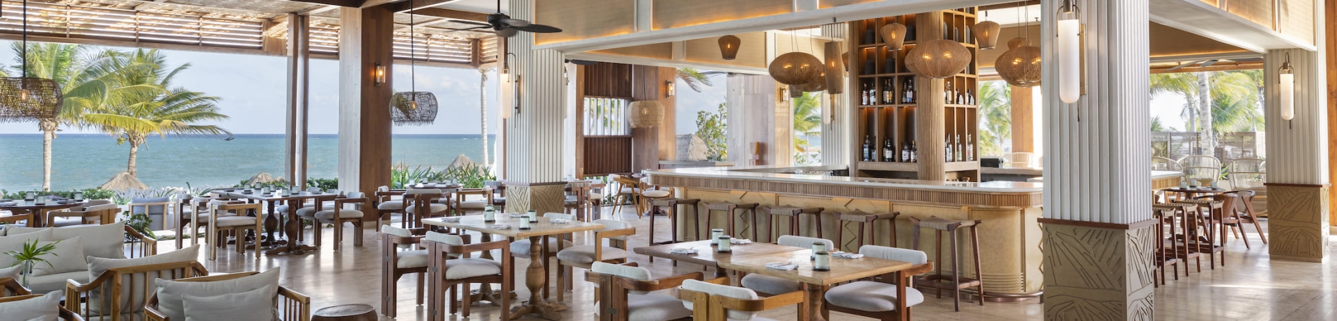 The indoor dining area of Fairmont Mayakoba's Brisas with ocean views.
