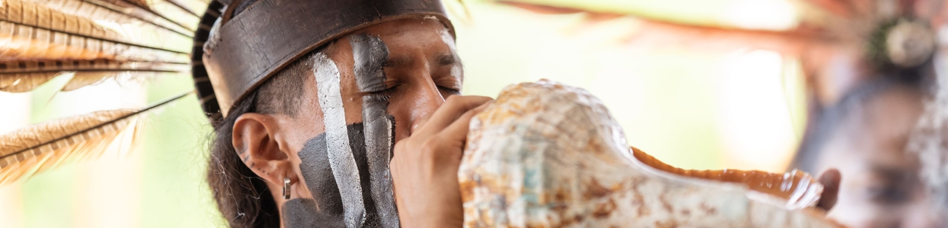 Man blowing a conch