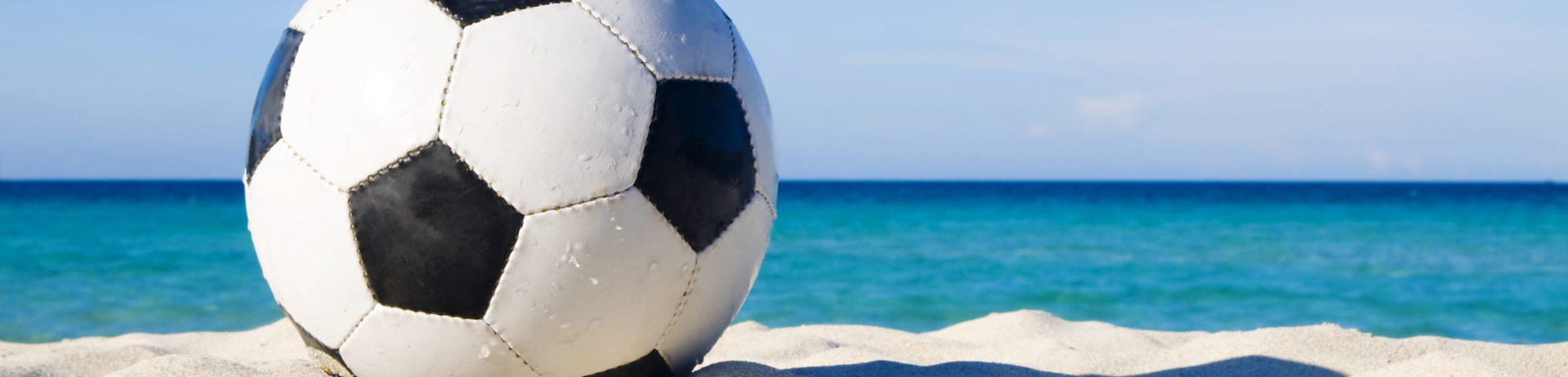 A soccer ball on a beach