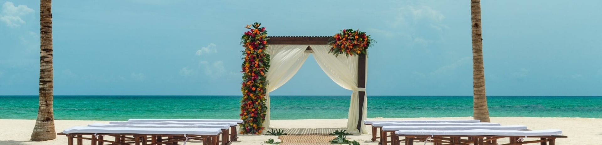 An oceanfront beach wedding aisle and archway.