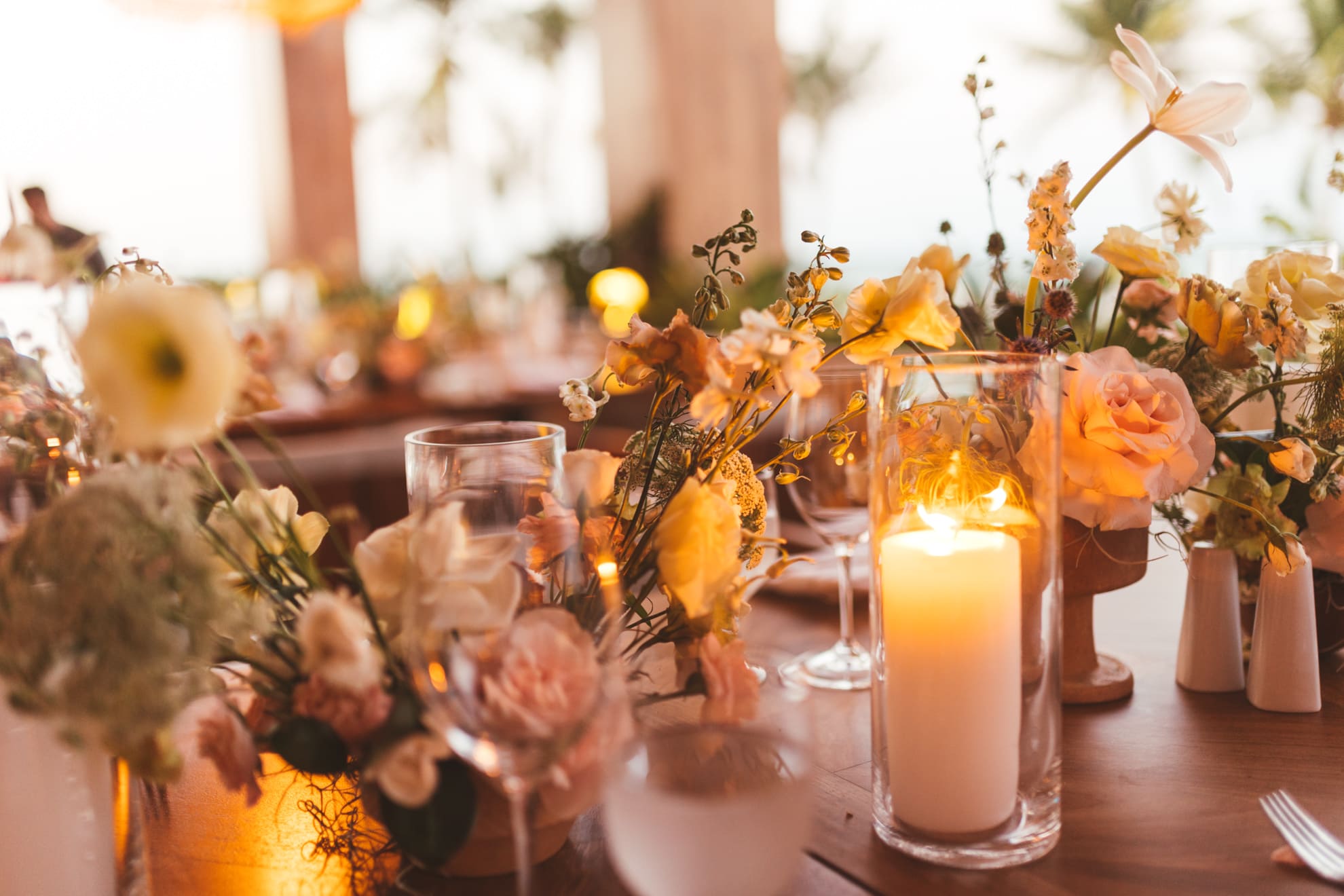 Closeup of candle and flower arrangement