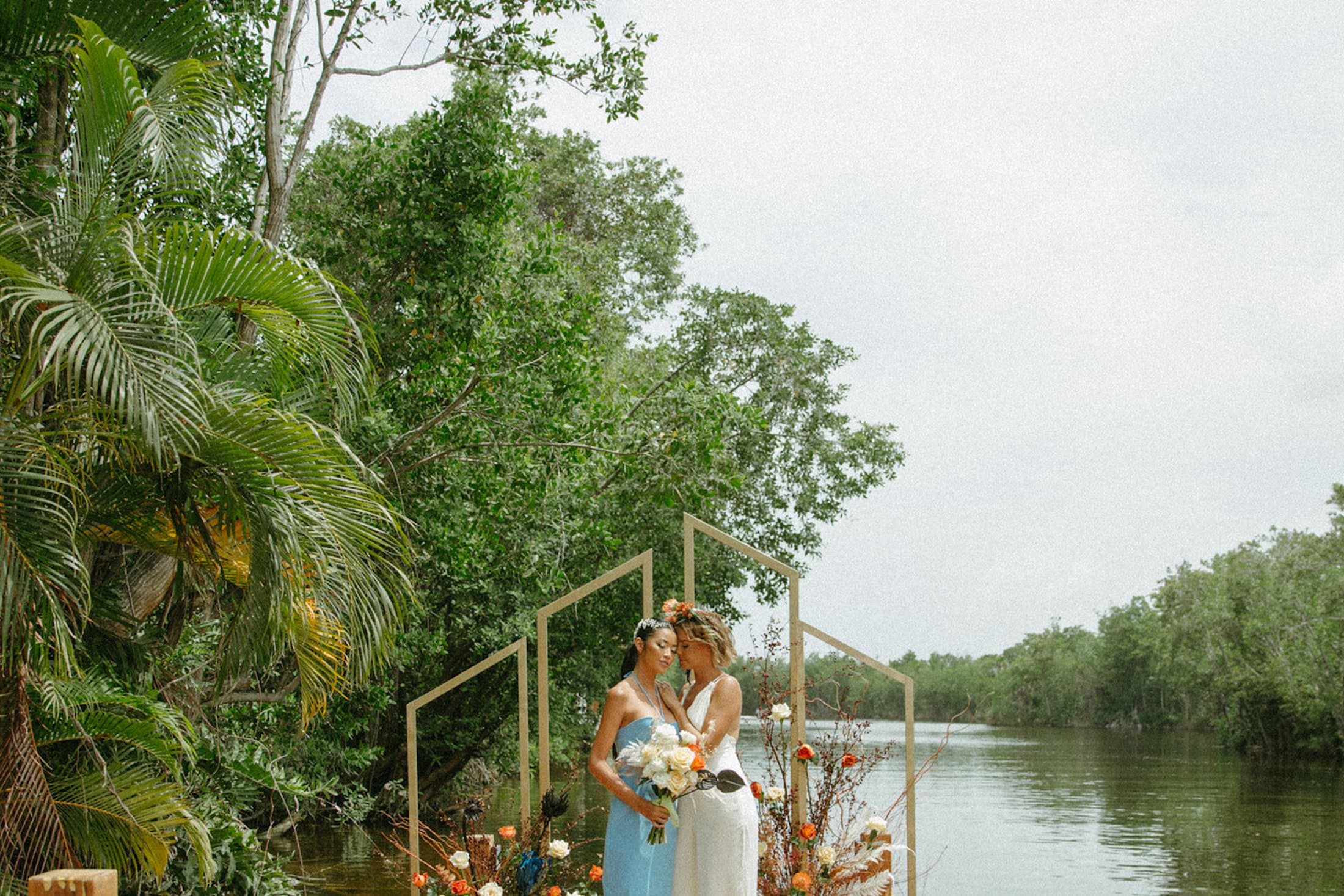 Young lesbian couple getting married by the river