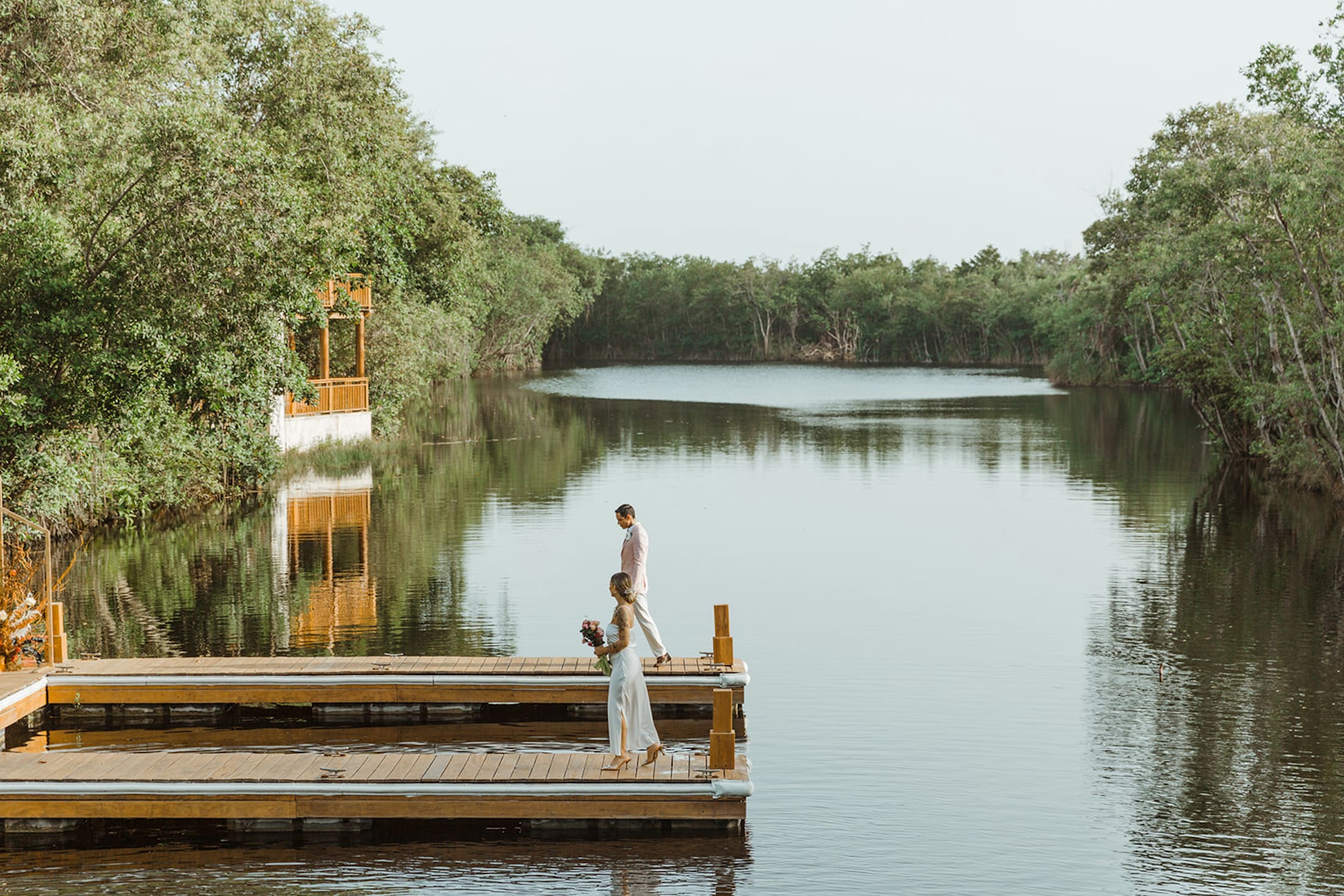 Wedding couple on the dock along the river