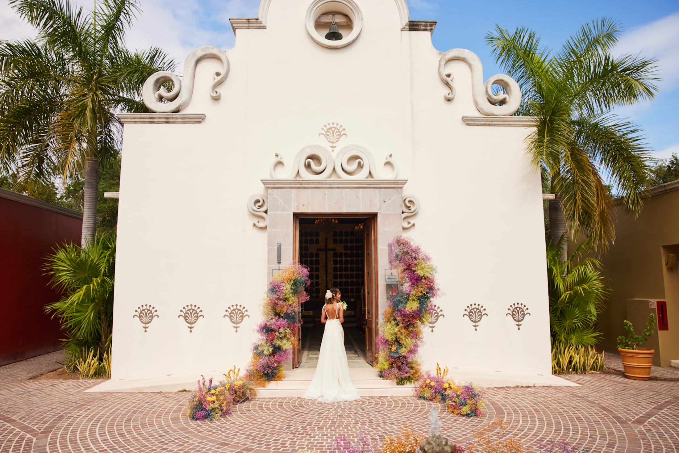 A bride standing outside a chapel