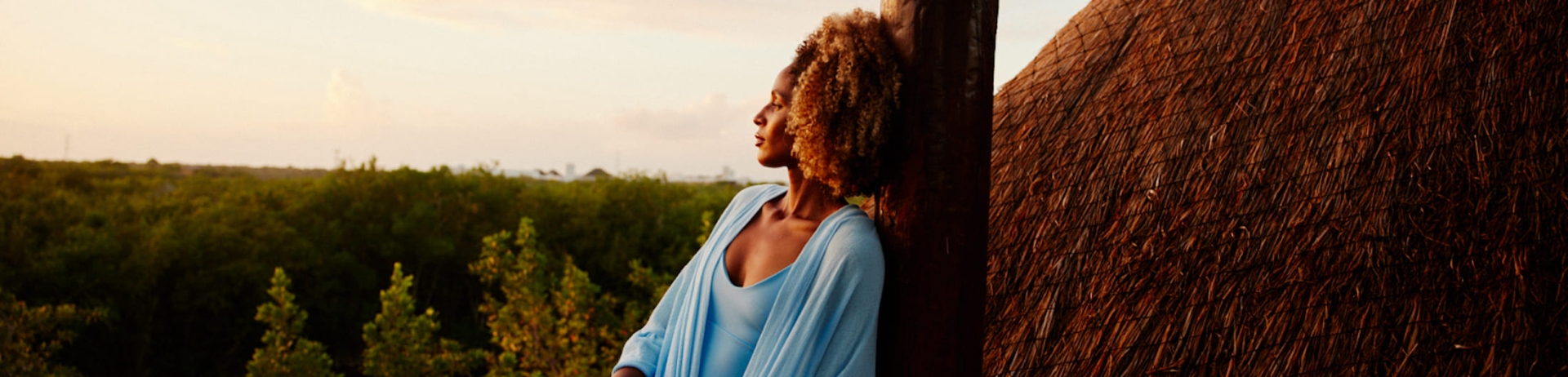 A woman sitting outside enjoying a view.