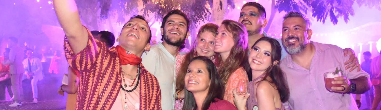 Group of people taking a selfie at a party