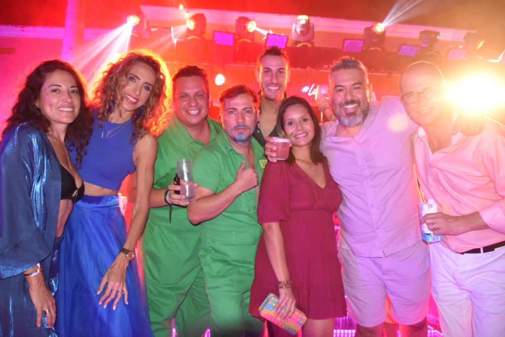 A group of people in a club smiling for a photo.