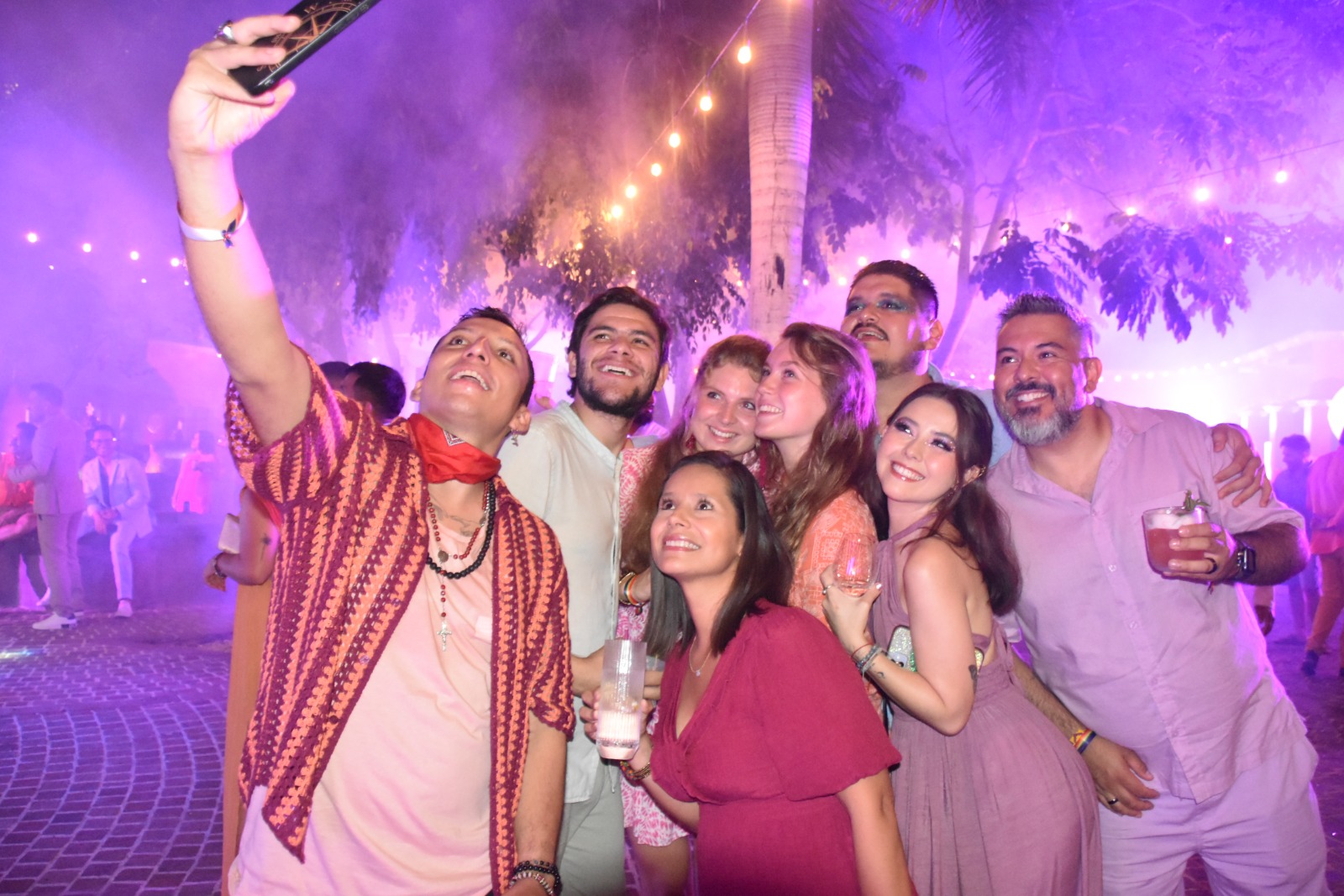 A group of people taking a selfie in a dance club.