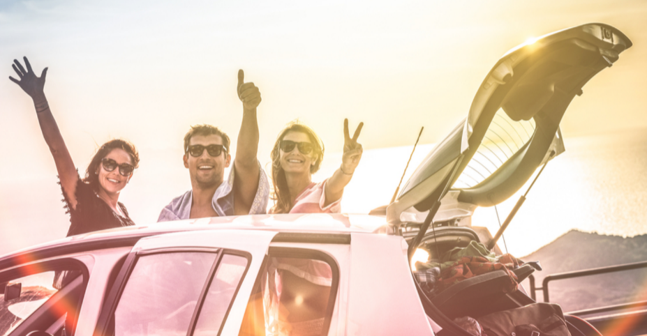 A group of friends packing a car for a road trip.